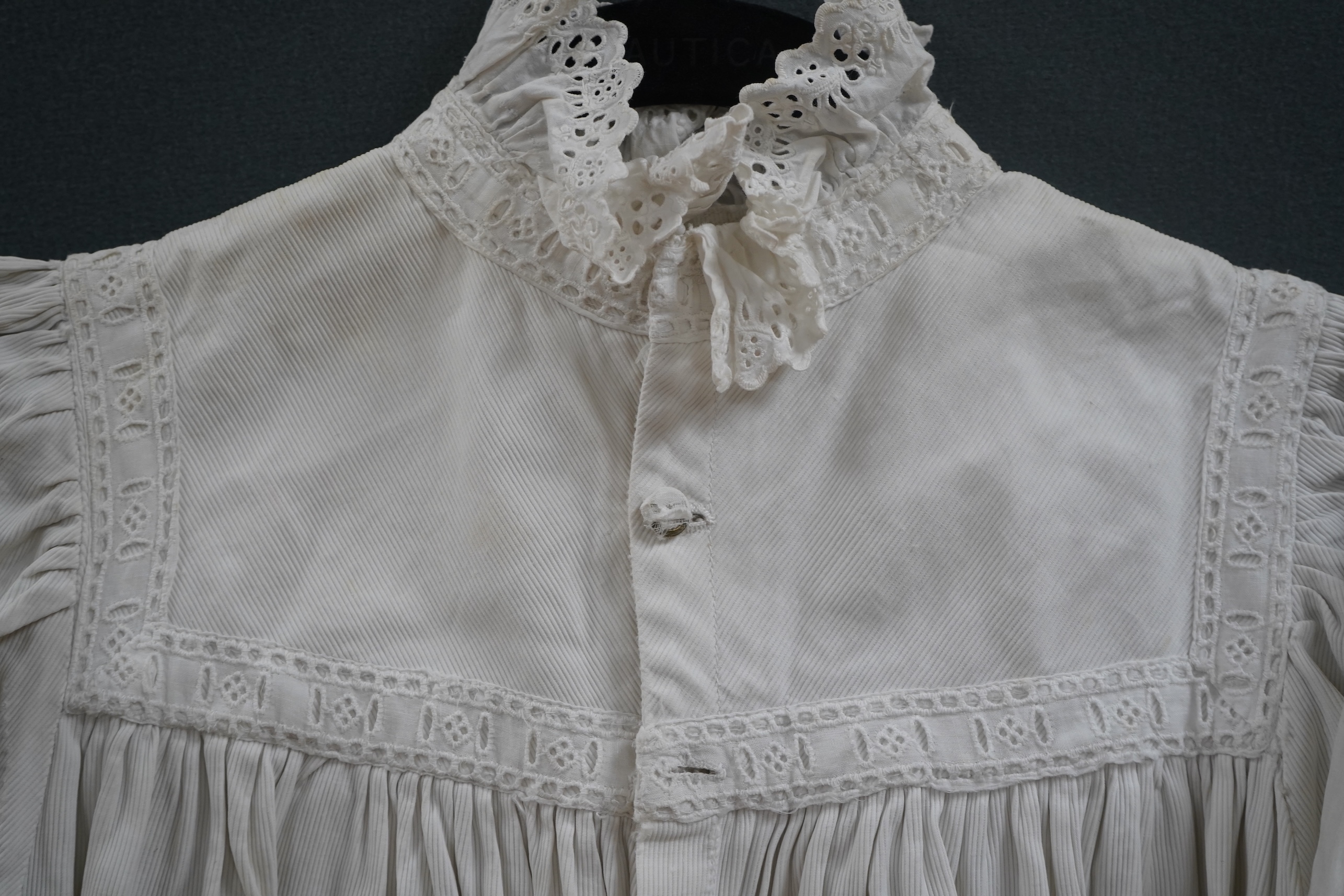 Two late 19th early 20th century girls summer dresses, one fine cotton with white worked collar cuffs and bodice, the other a cotton twill with anglaise collar large puff sleeves and gathered across the chest, lawn dress